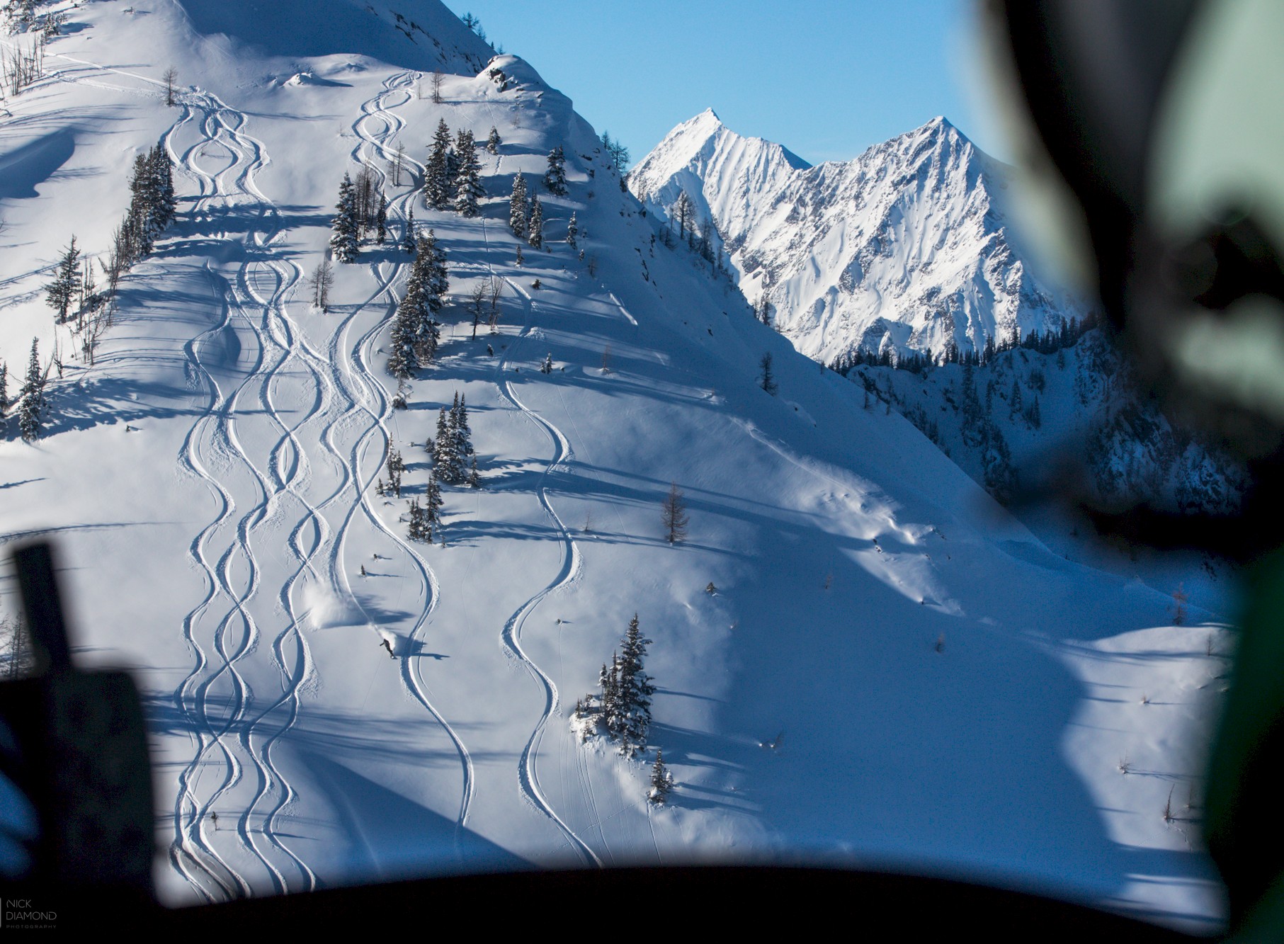 Small group heliskiing powder tracks at Stellar Heliskiing.