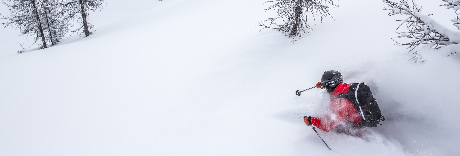 Guest skiing powder and trees at Stellar Heliskiing.