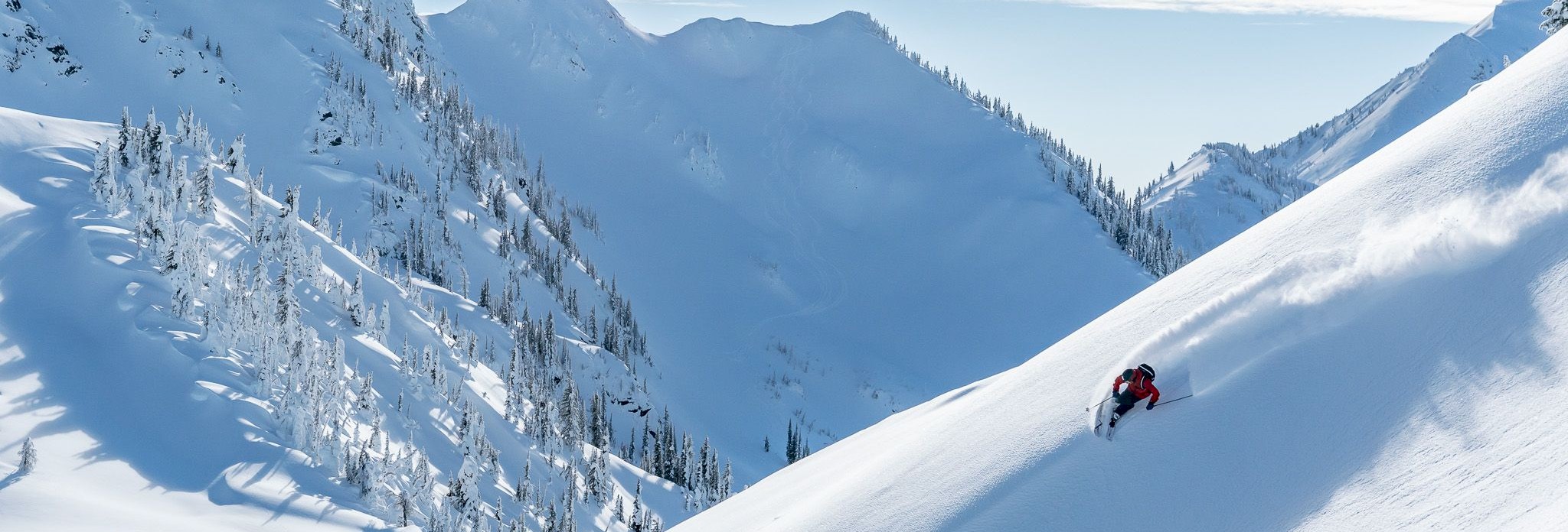 Guest skiing powder ridge line at Stellar Heliskiing, Kaslo, BC.